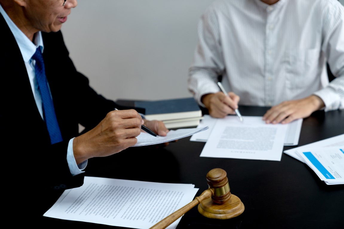 Lawyer,Pointing,To,Document,And,Discussing,Legal,Text,In,Lawsuit